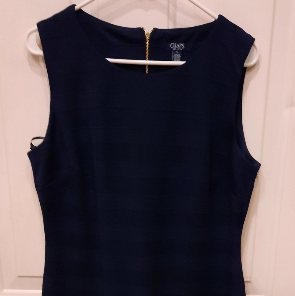 Navy blue dress, there's a pull in the material that can be tucked into fabric.